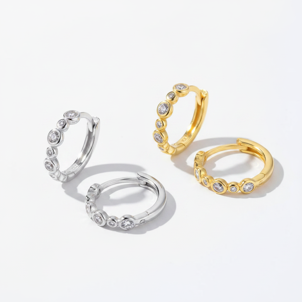 Gold and silver hoops on white surface