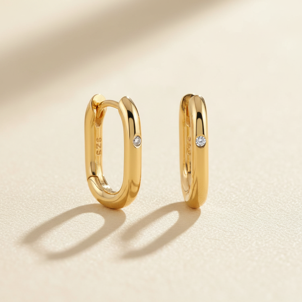 Gold hoops on ivory surface